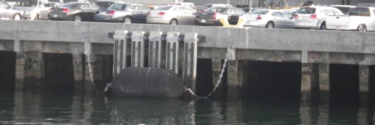 large fender suspended from cruise ship dock